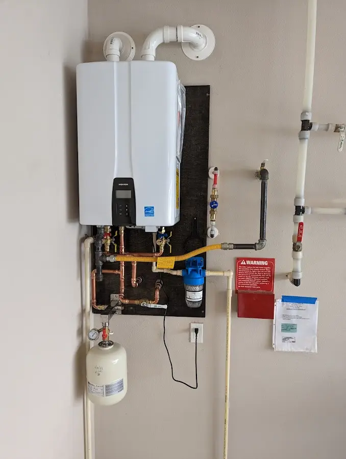 Professional plumber installing copper piping in a Newcomerstown home